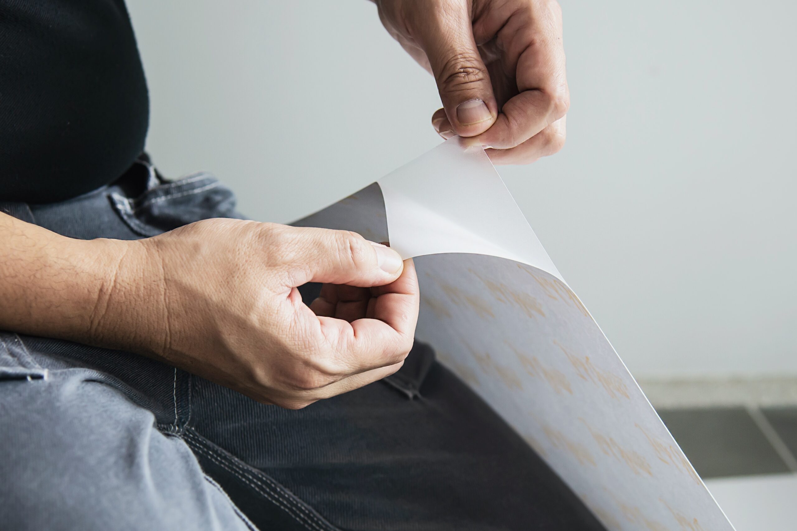 man installing sticker film to mirror window house interior decoration